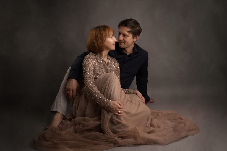 A romantic family photoshoot in Wolverhampton, highlighting the deep connection between a couple in an intimate, soft-lit studio portrait.